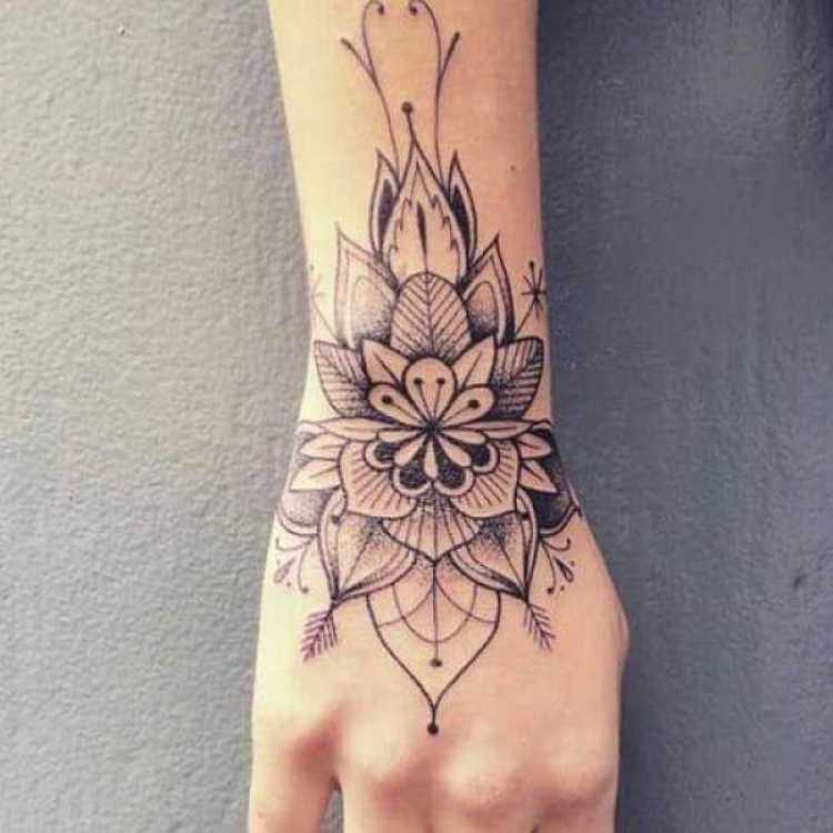 Female tattoo on hand and arm