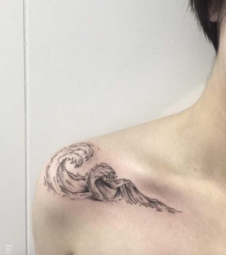 Female tattoo with sea wave design