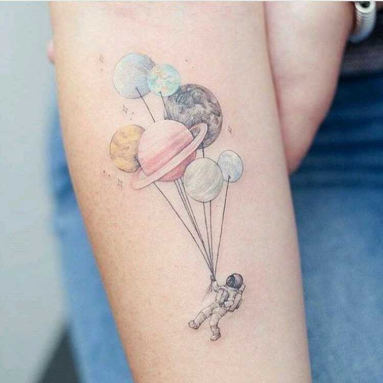 Tattoo with image of astronaut and planets