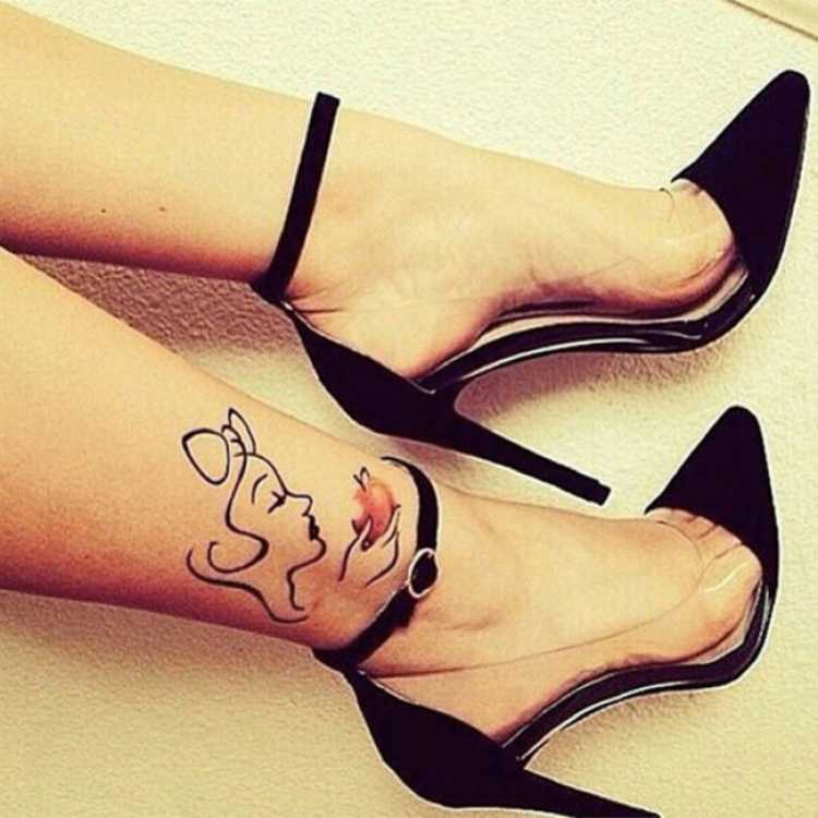 Delicate feminine tattoo with a drawing on the ankle of a woman eating an apple