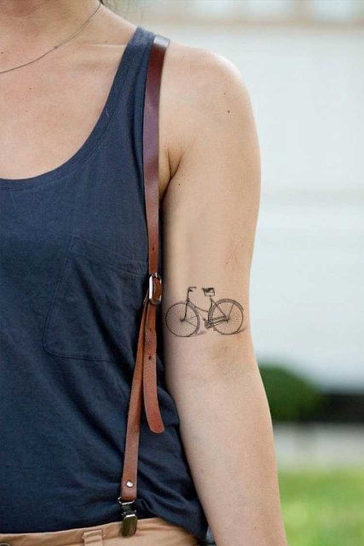 Tattoo with a bicycle design on the arm