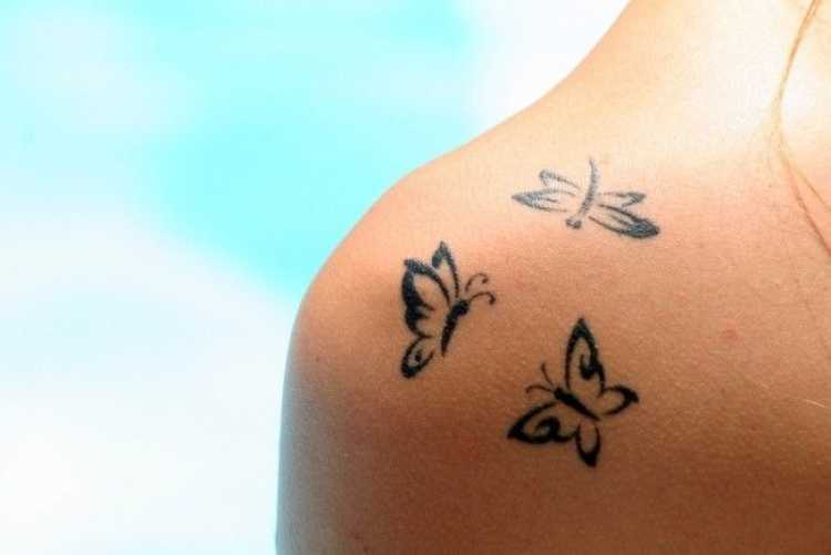 Shoulder tattoo with three butterflies