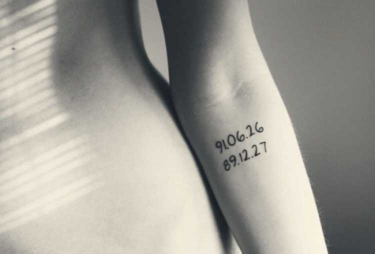 Numbers tattooed on a woman's arm