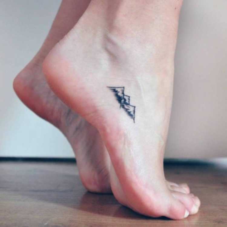 Delicate feminine tattoo on the foot