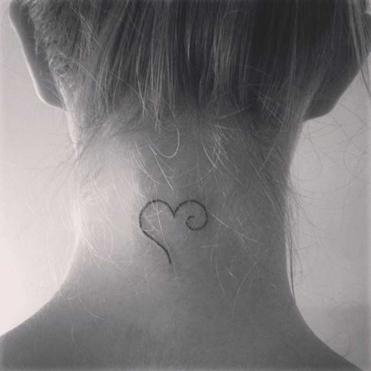 Small female tattoo design on the back of the neck