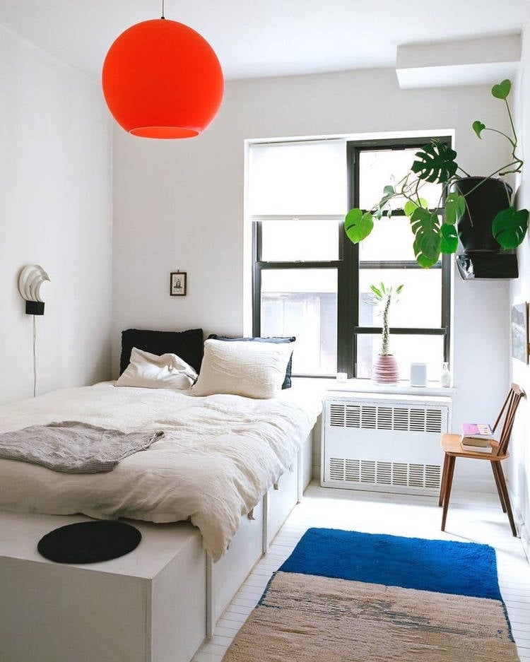 Small room decorated with drawers on the bed.