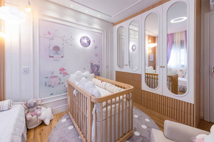 Bedroom with mirrors in the closet and wooden crib.