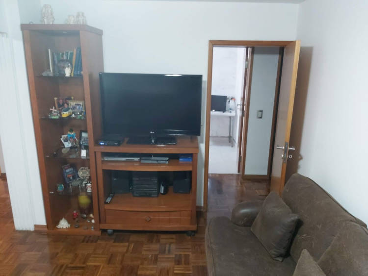 Old room with dark brown rack and TV.