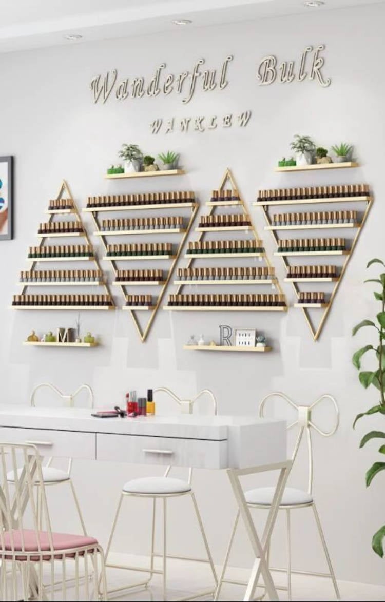 Beauty salon with triangle nail polish shelves.