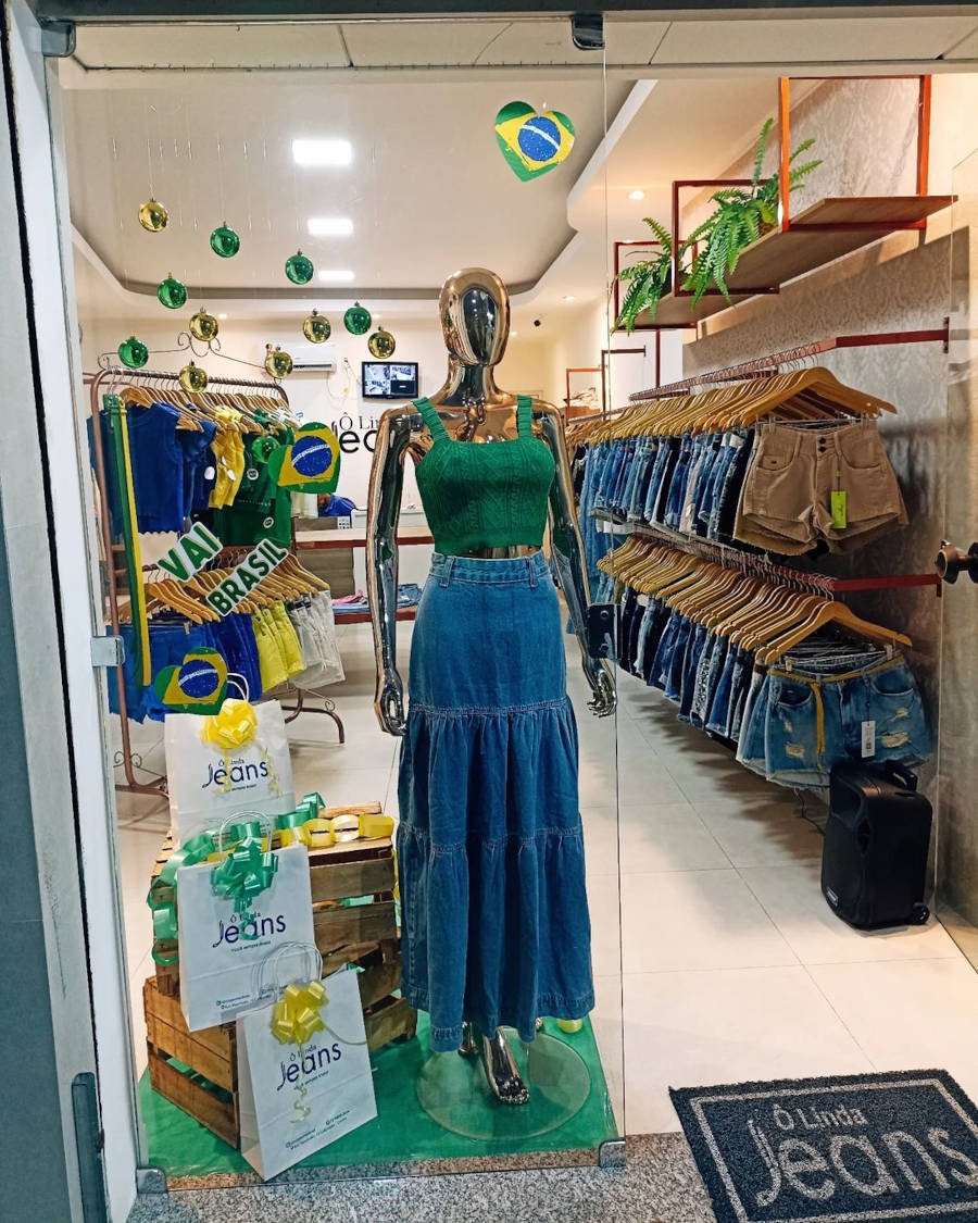 Mannequin with denim skirt and green crop top.