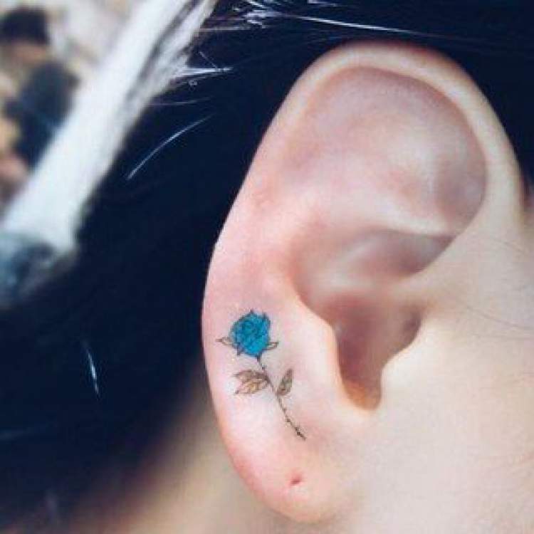 Delicate flower tattoo on ear