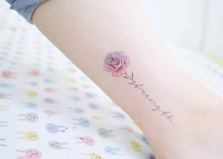 Delicate tattoo with flower design