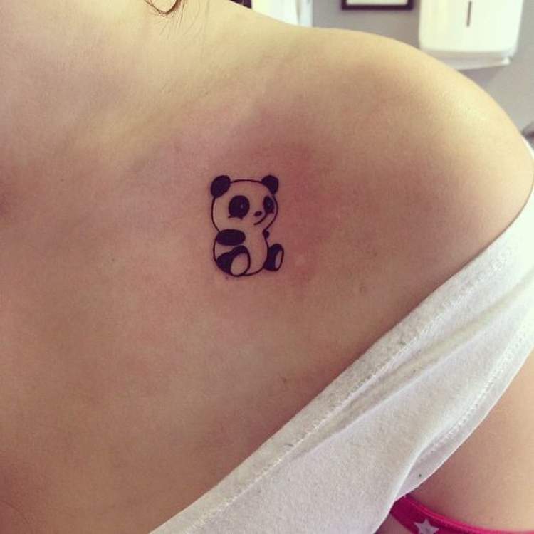 Delicate panda bear tattoo on the side of the shoulder