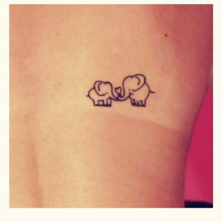 Delicate two elephant tattoo