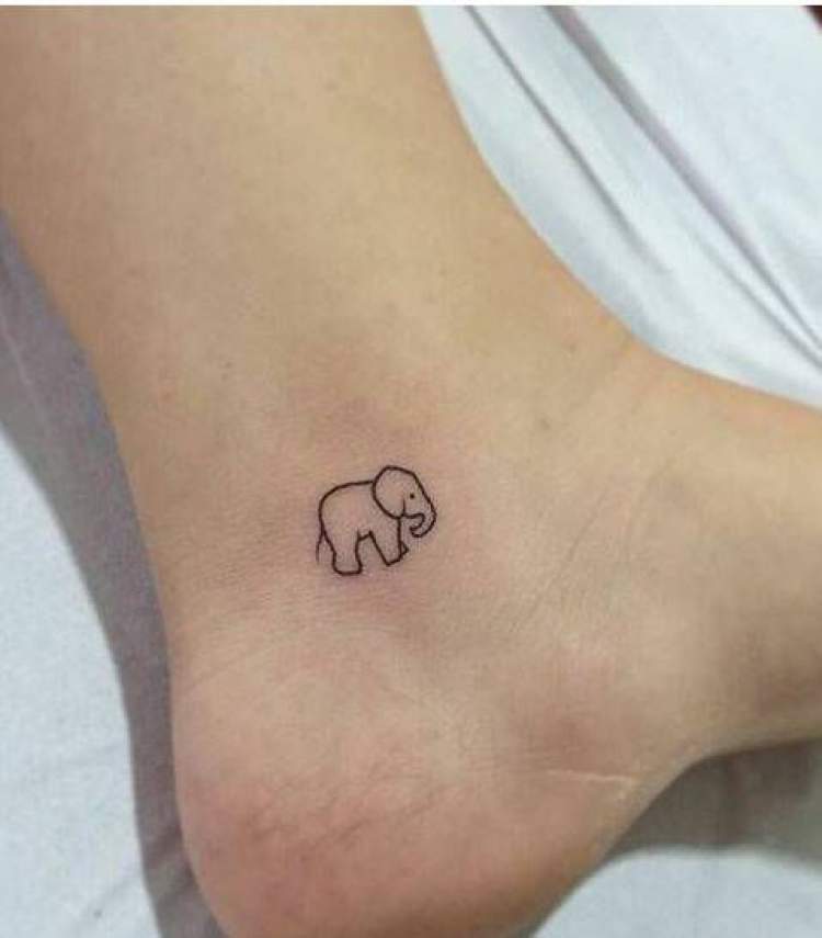 Delicate elephant tattoo on the foot next to the heel