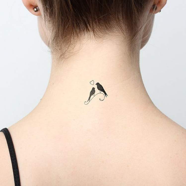 Delicate tattoo on the back of the neck with two birds dating