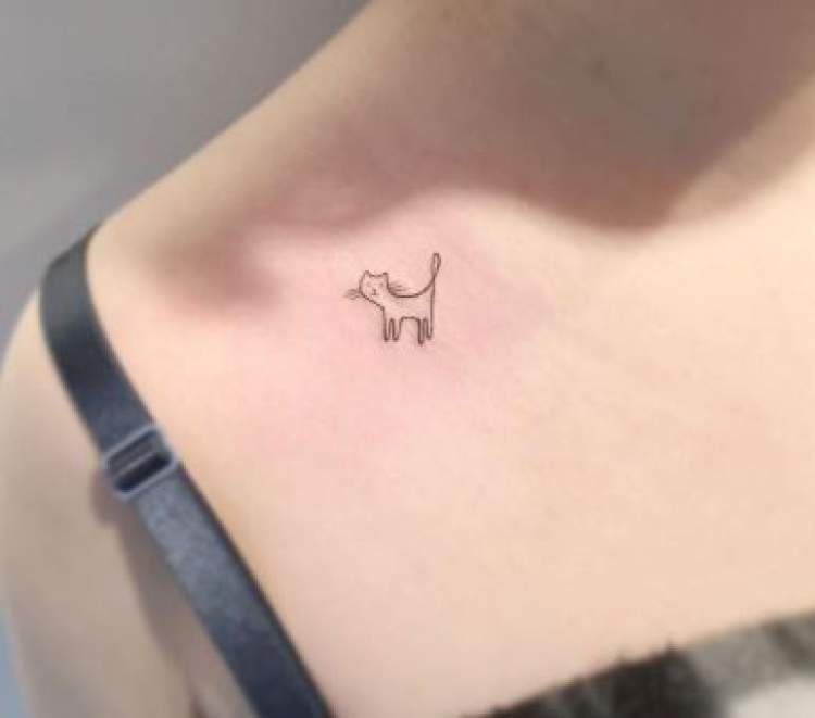 Cat tattoo on the side of the shoulder