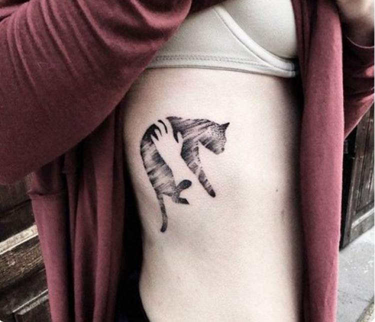 Cat tattoo on rib