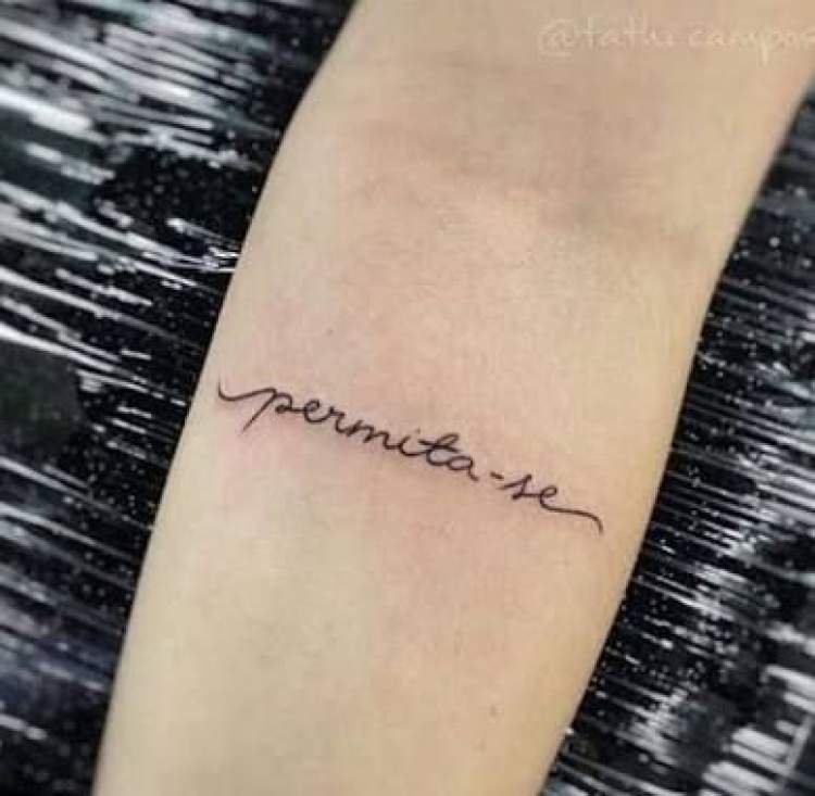 Photo of tattoo with delicate writing on arm