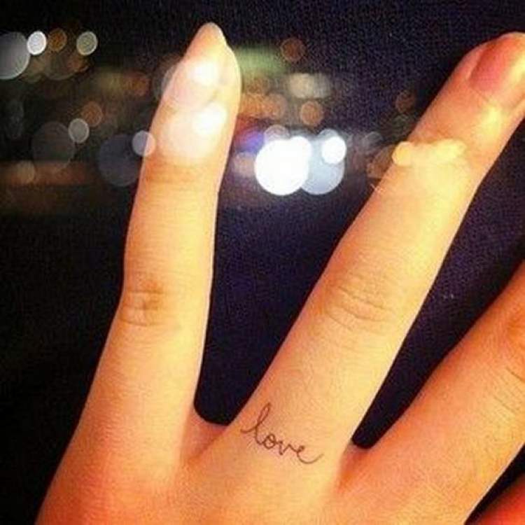 Tattoo with the word love on the finger