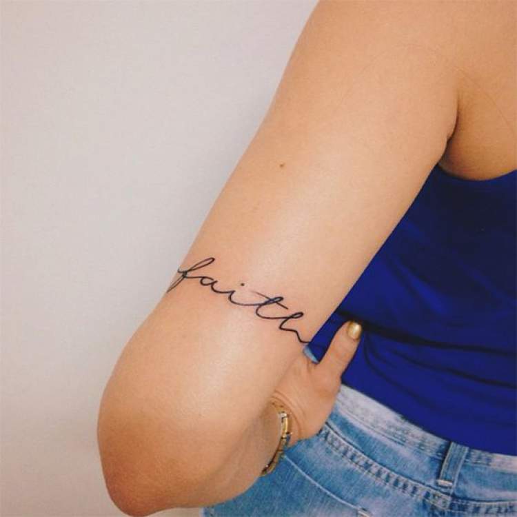 Tattoo with delicate writing on arm