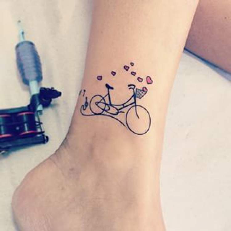 Tattoo of a small bicycle on the ankle