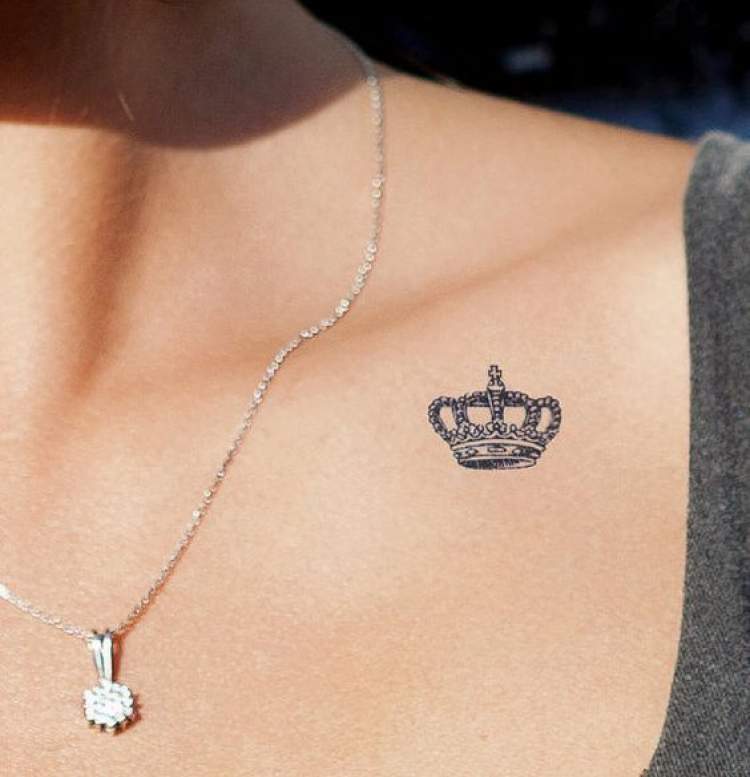 Delicate crown tattoo on shoulder