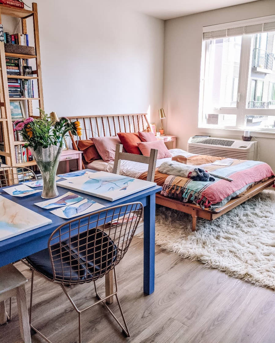 Space with plush carpet and blue dining table.