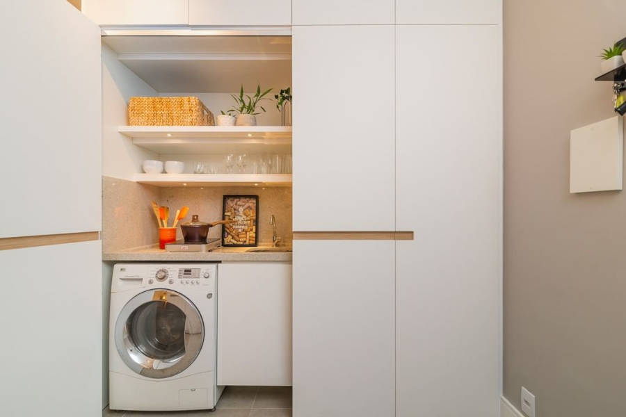 Hidden kitchen with white doors.