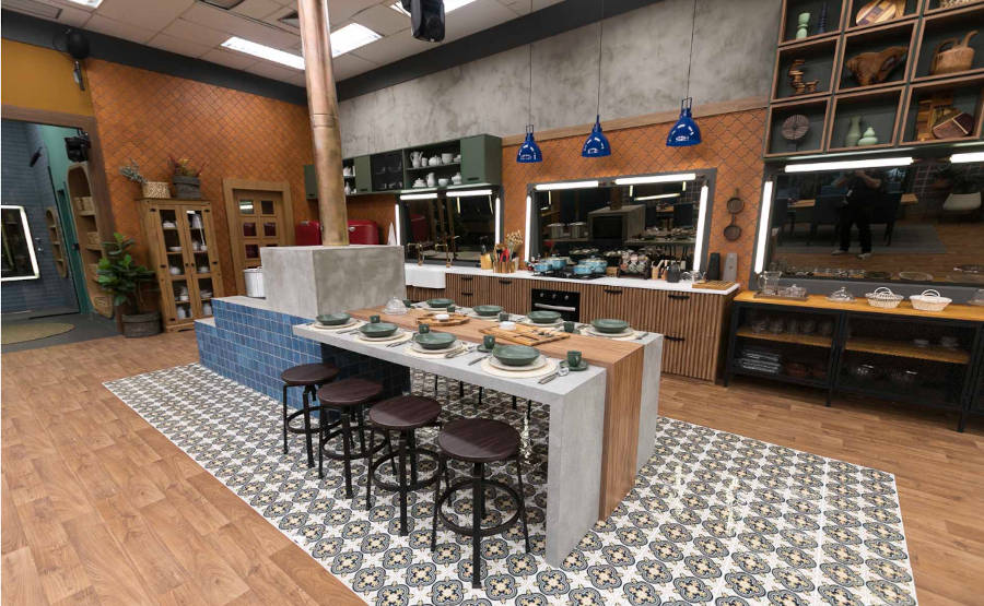 Kitchen with wood stove and table decorated in A Fazenda 2022 decor.