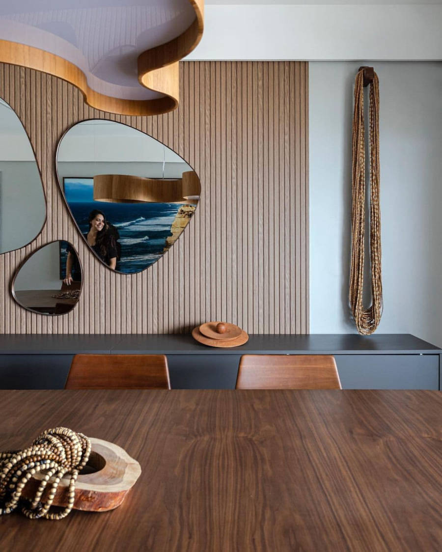 Slatted wall with three mirrors.