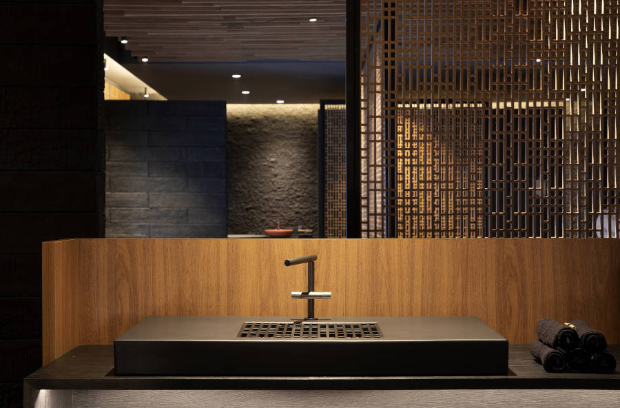 Dark bathroom with modern sink.