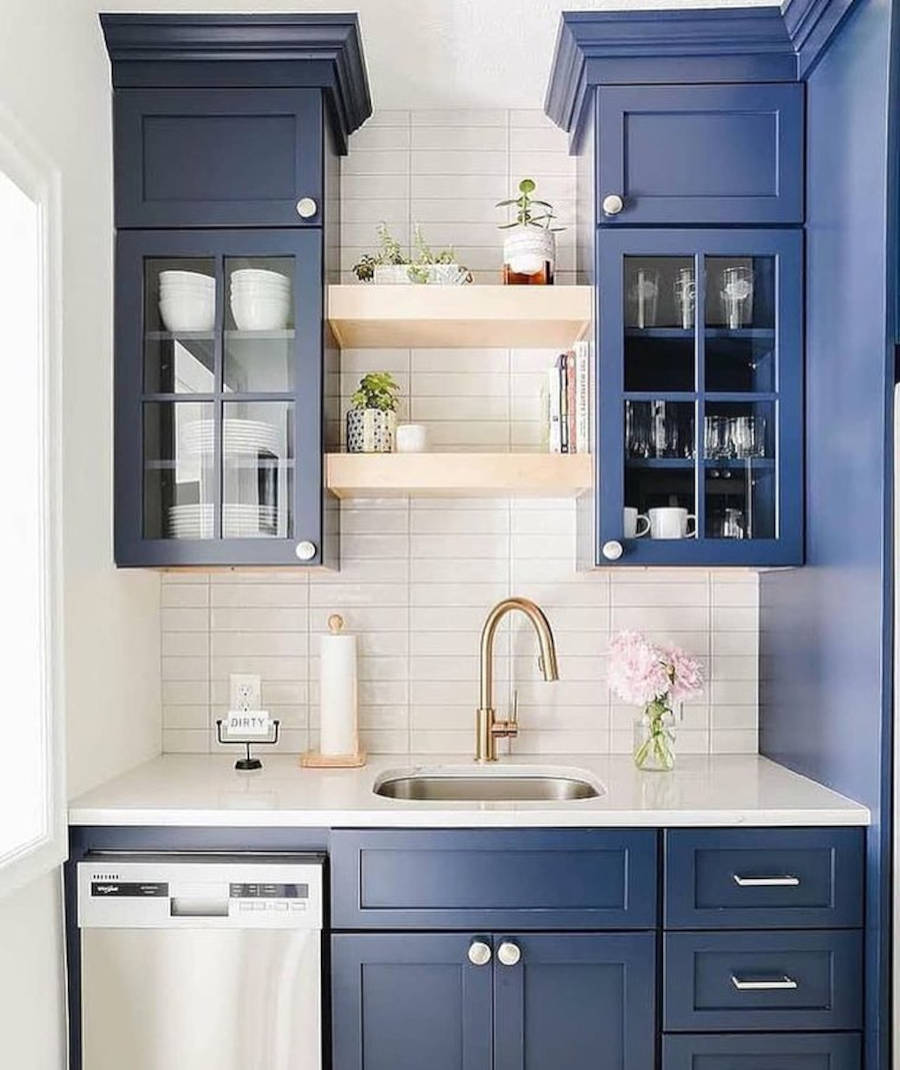 Mini kitchen with dark blue cabinets.