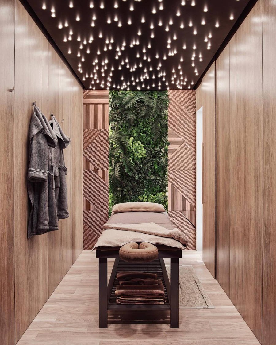 Small massage room with vertical garden and wall hooks with robes. 