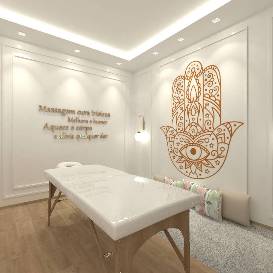 White massage room with positive message and wall art.