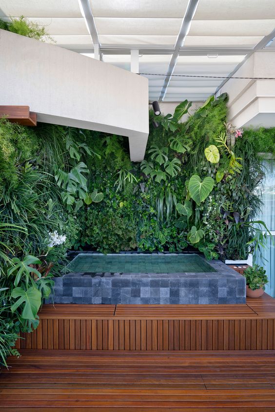 Wall with plants and square pool.