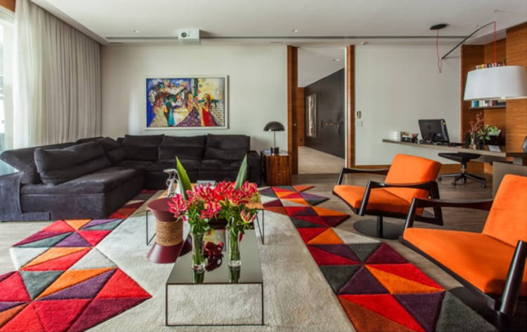 Living room with colorful rug.