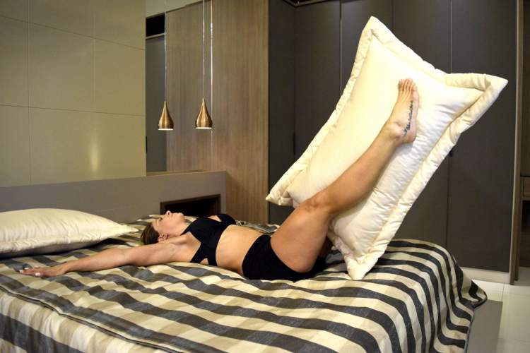 Jo Damiani doing exercises in bed