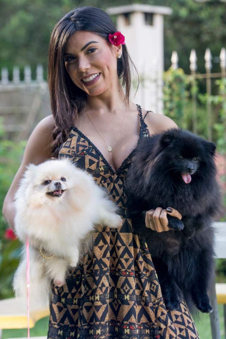 Priscila Rocha with two puppies