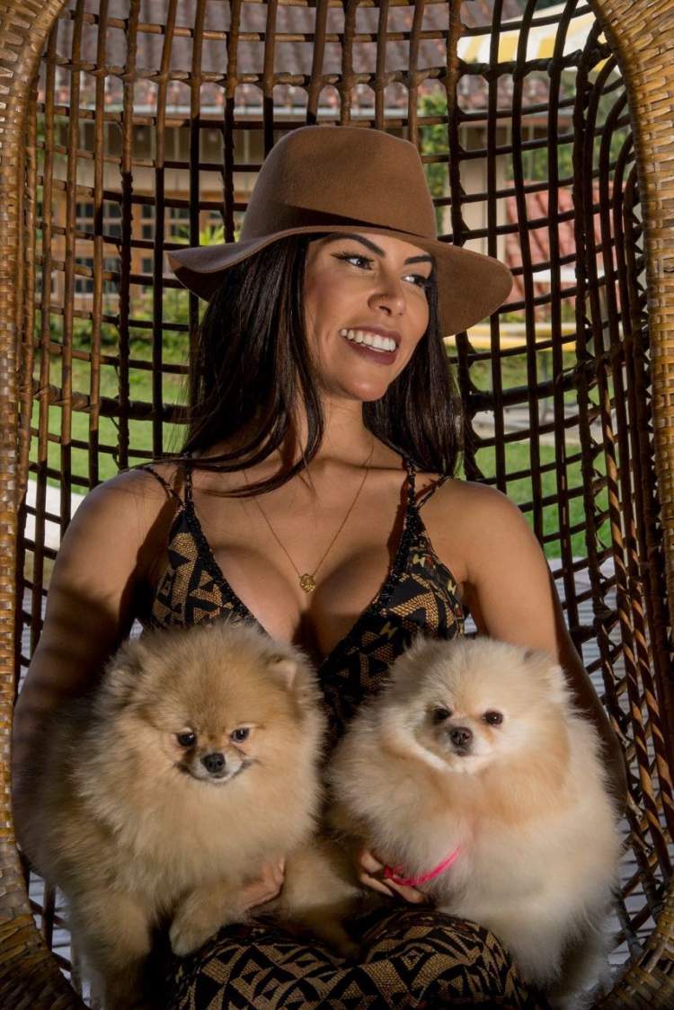 Priscila Rocha resting with her dogs