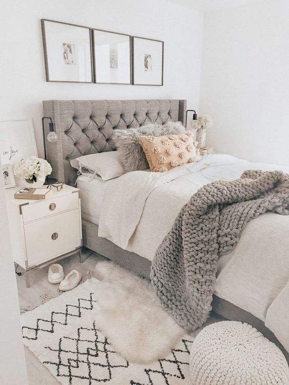 Bed with gray headboard.