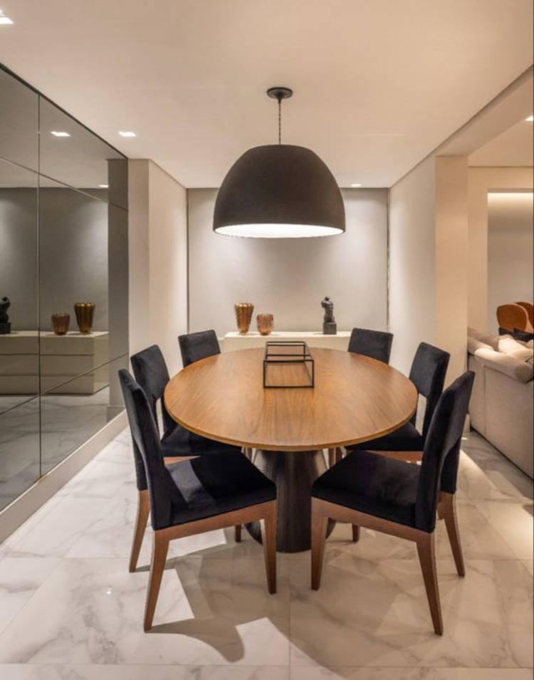 Oval table with black chairs.