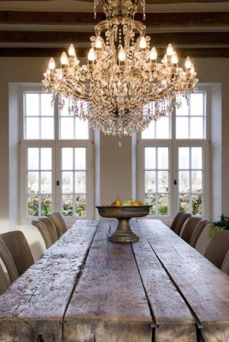 Crystal chandelier under rustic table.