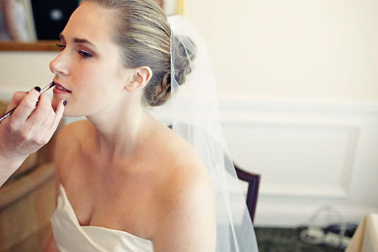 photo of the bride putting on makeup