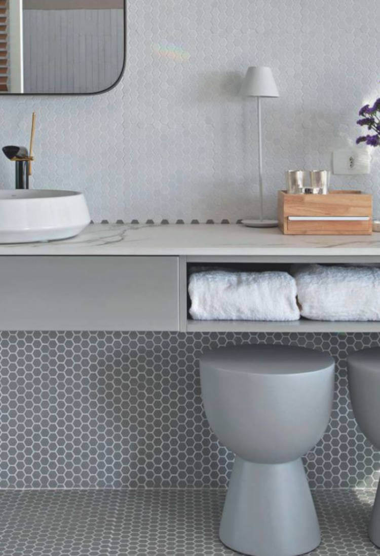 Gray toilet with tiles.