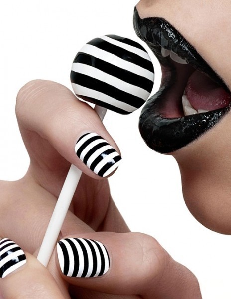 Carnival nails decorated with black and white stripes