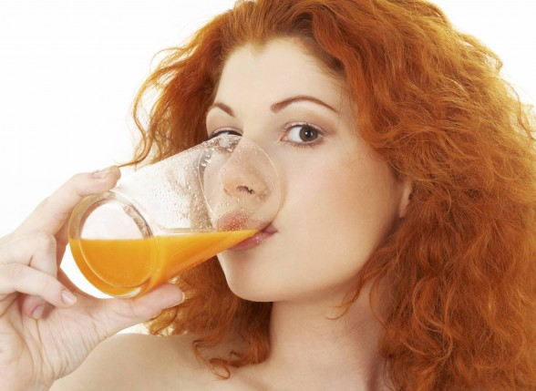 woman drinking carrot juice