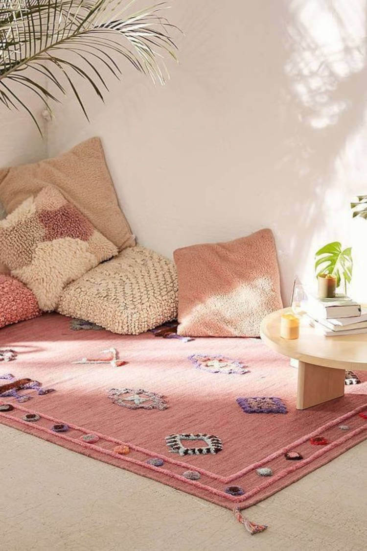 Pink rug and cushions.