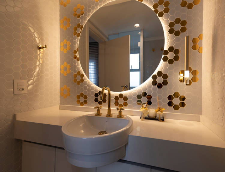 White bathroom with golden decor.