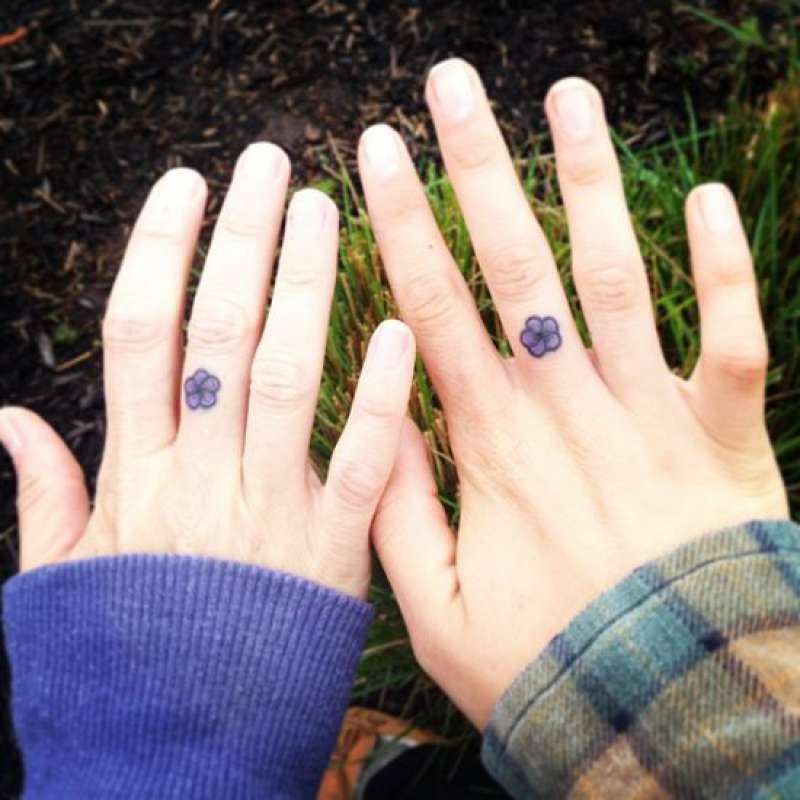 Female hands tattooed with flower